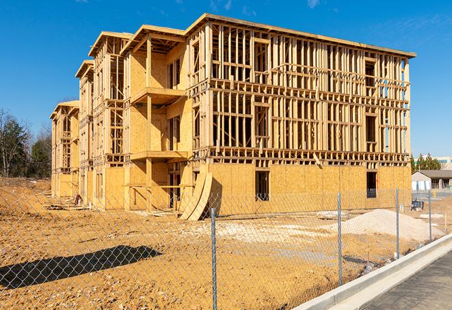 a close-up of temporary chain link fences enclosing a job site, signaling progress in the project's development in Culver City